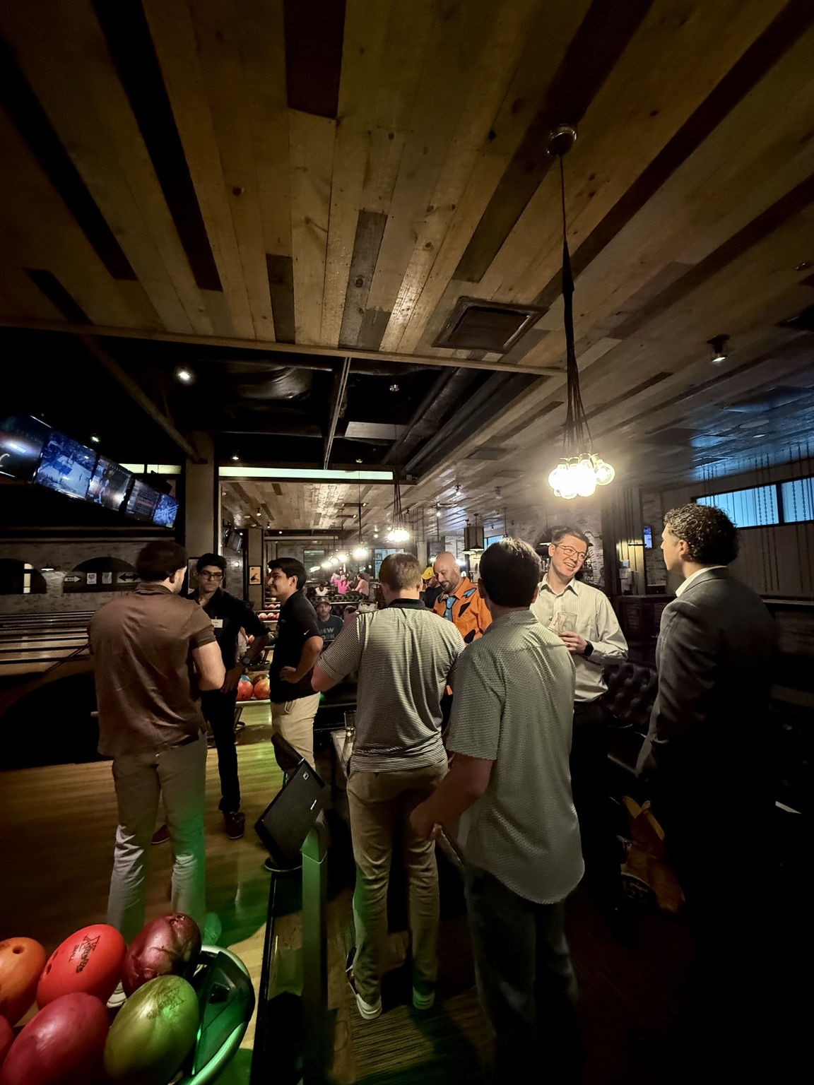 Attendees networking at bowling event